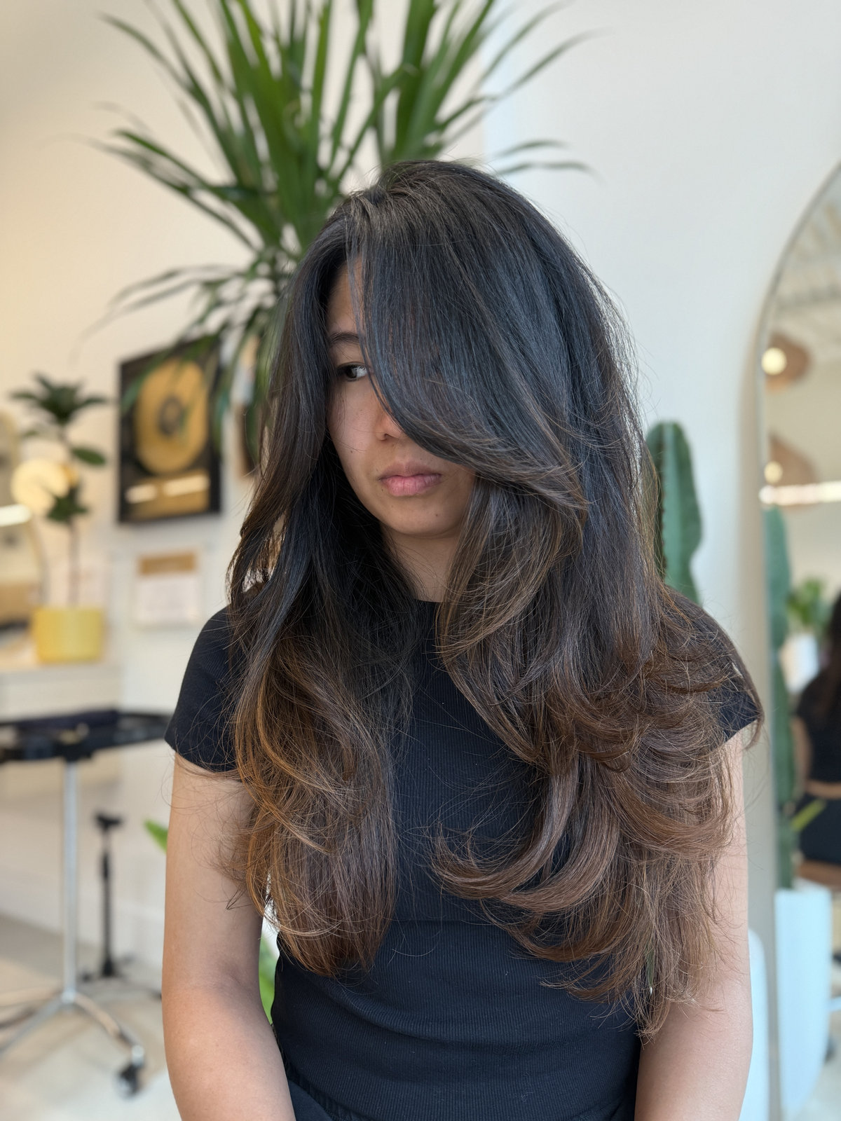 Long layers with caramel balayage sweeping across face